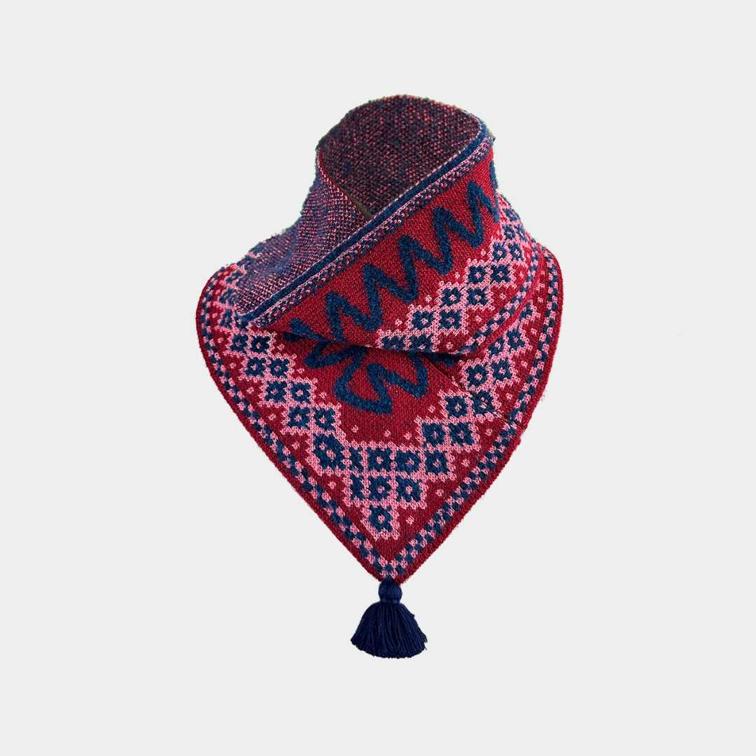 A red and navy blue patterned knit bandana with a tassel, displayed on a light gray background.