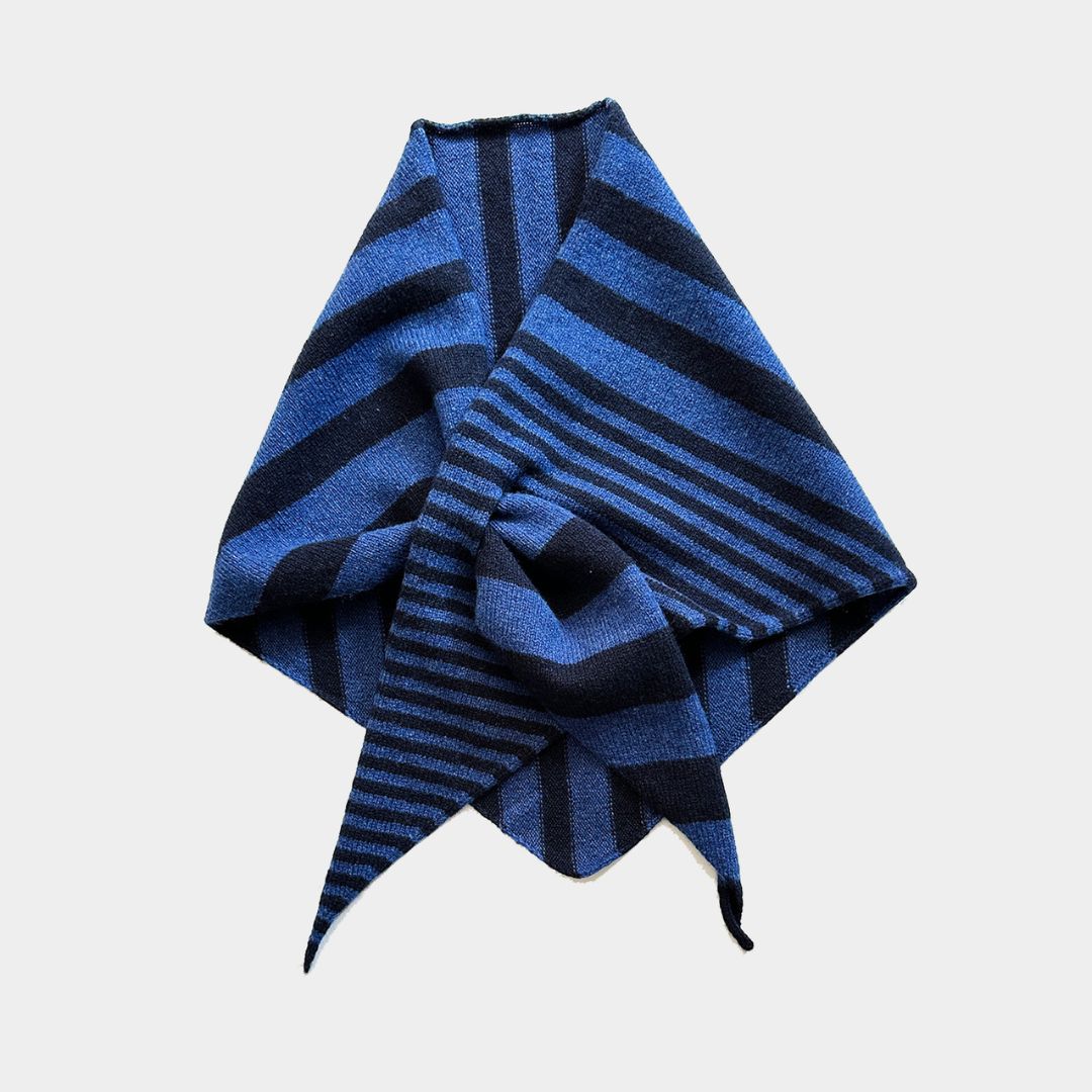 A folded blue and black striped knit scarf or bandana, styled in a knot against a solid light gray background.