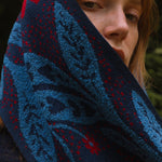 Person wearing a blue and red patterned scarf