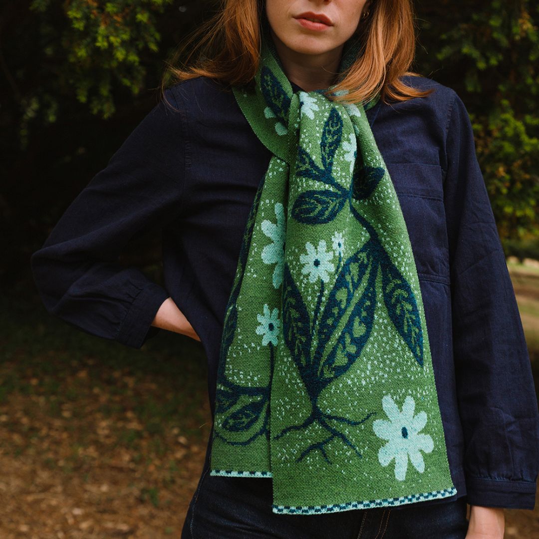 green pattered scarf word by a woman in the woods.