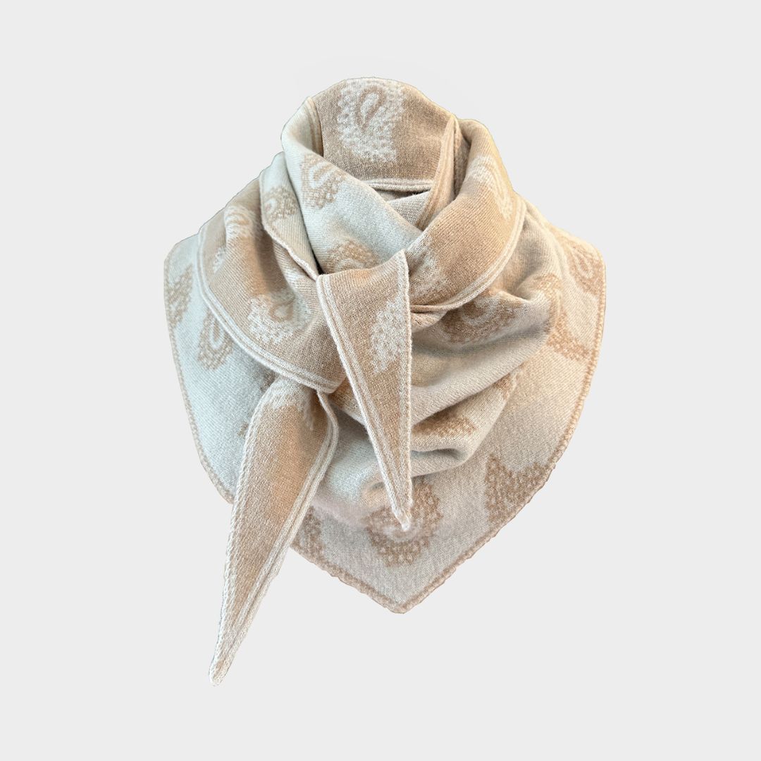 A square scarf with a beige and off-white paisley pattern, styled in a loose knot on a light gray background.
