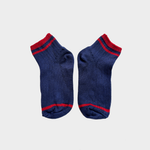 A pair of navy blue knit ankle socks with red stripes at the cuff, toe, and heel, displayed flat against a light gray background.