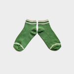 A pair of green crew socks with white stripes at the ribbed cuffs and toes, displayed flat against a light gray background.
