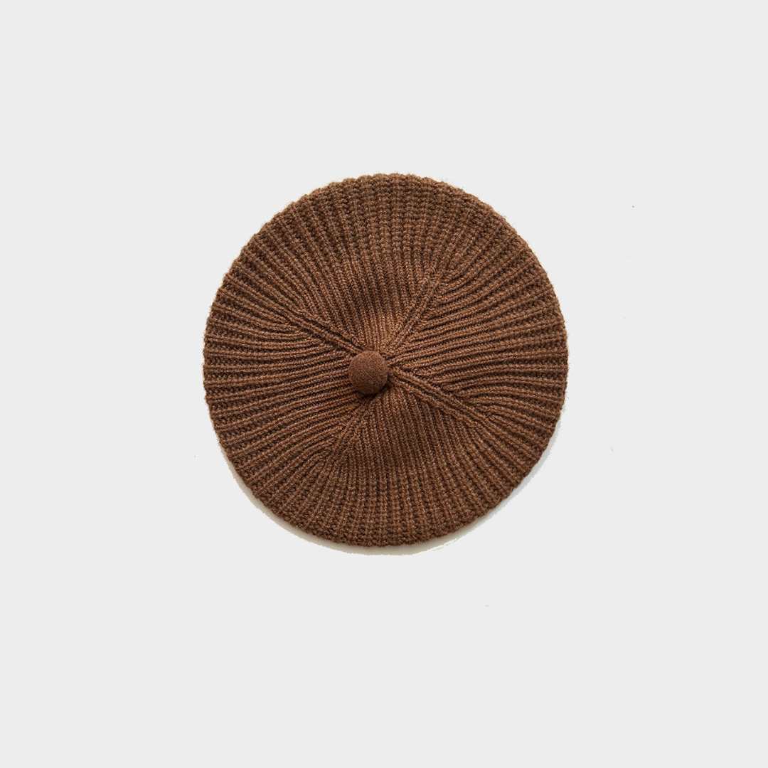 A brown ribbed knit beret-style hat with a small top button, photographed from directly above on a light gray background.