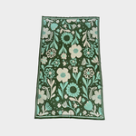 A blanket with an all-over floral pattern, shown flat against a light gray background. The design features a dark forest green base with large and small flowers, leaves, and stems in mint green, cream, and white.