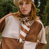 model in the woods wearing check cardigan in cream and brown.