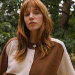 model in the woods wearing check cardigan in cream and brown.