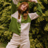 model in the woods wearing check cardigan in cream and green.