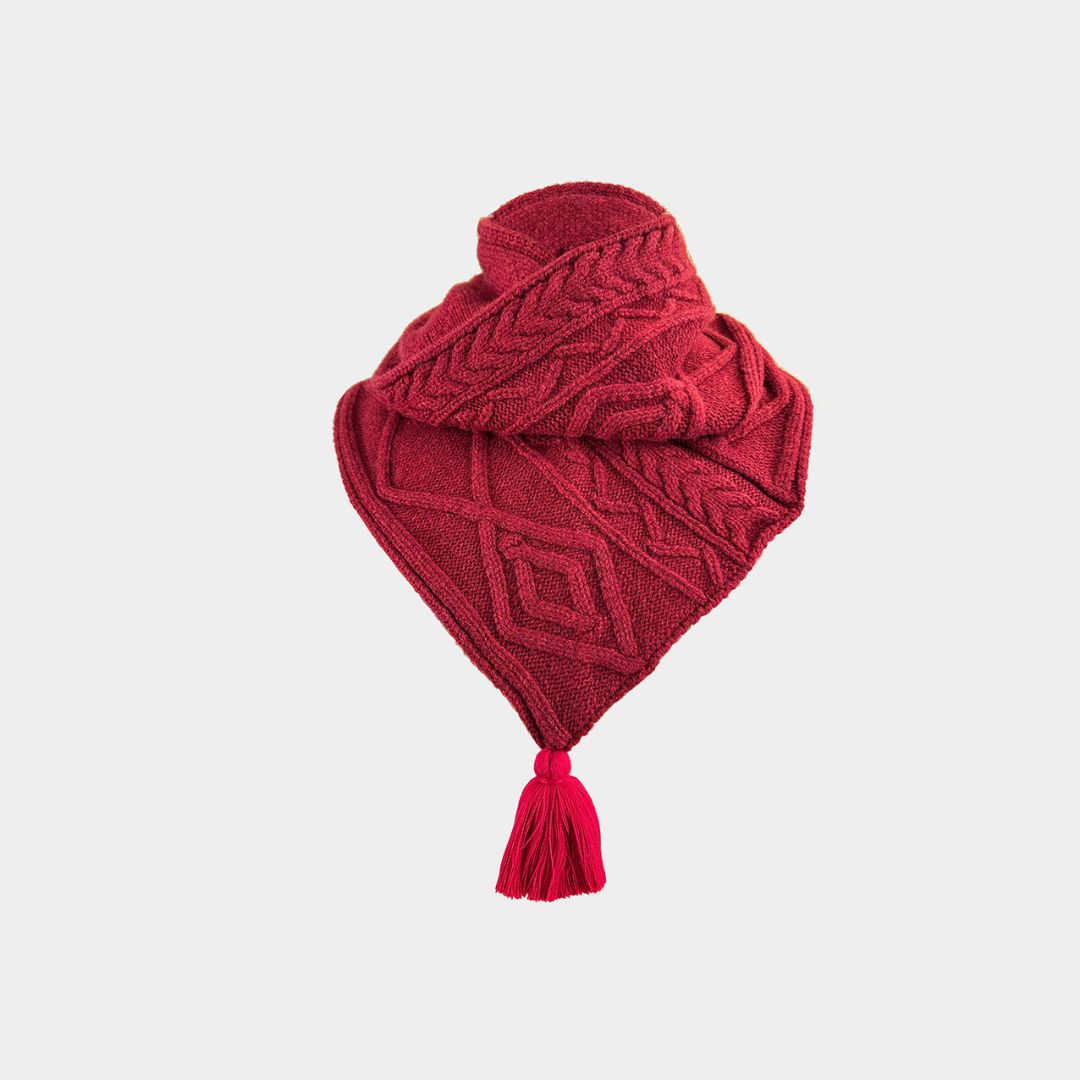 A red cable knit scarf on a white background.