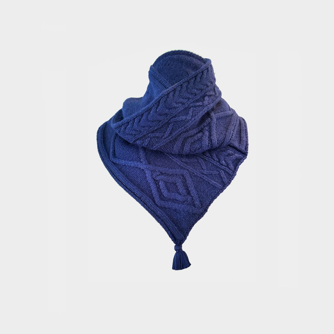 a blue cable knit scarf on a white background.