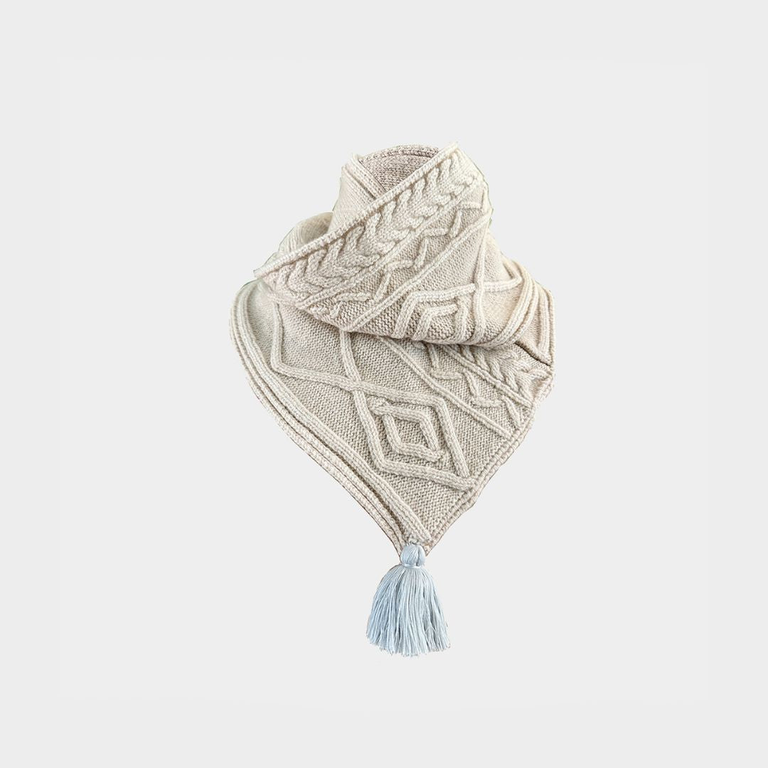 a cream cable knit scarf on a white background.