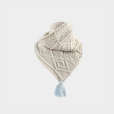 a cream cable knit scarf on a white background.