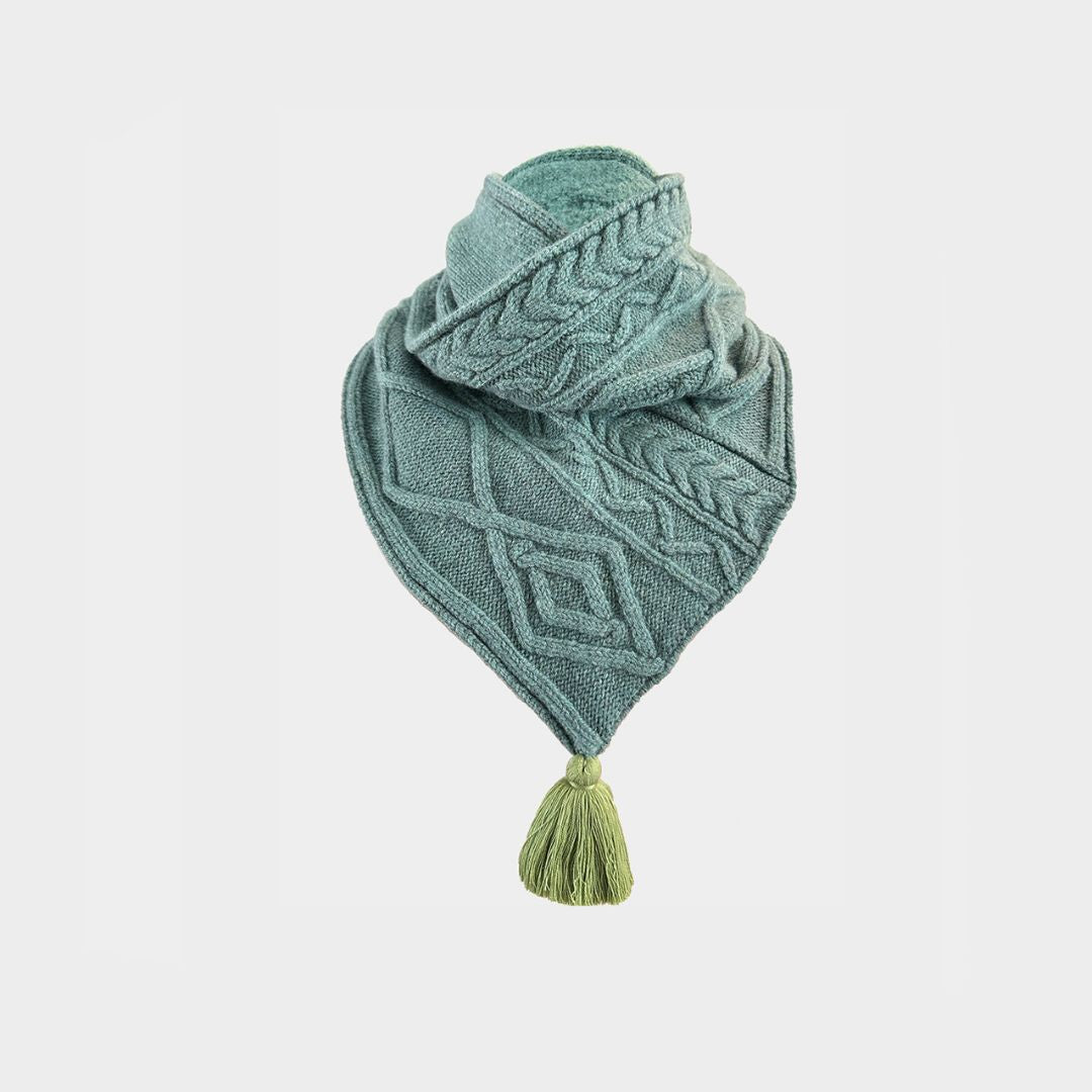 A green cable knit scarf on a white background.