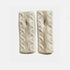 A pair of cream-colored cable-knit wrist warmers with a textured chevron pattern, displayed side-by-side on a light gray background.