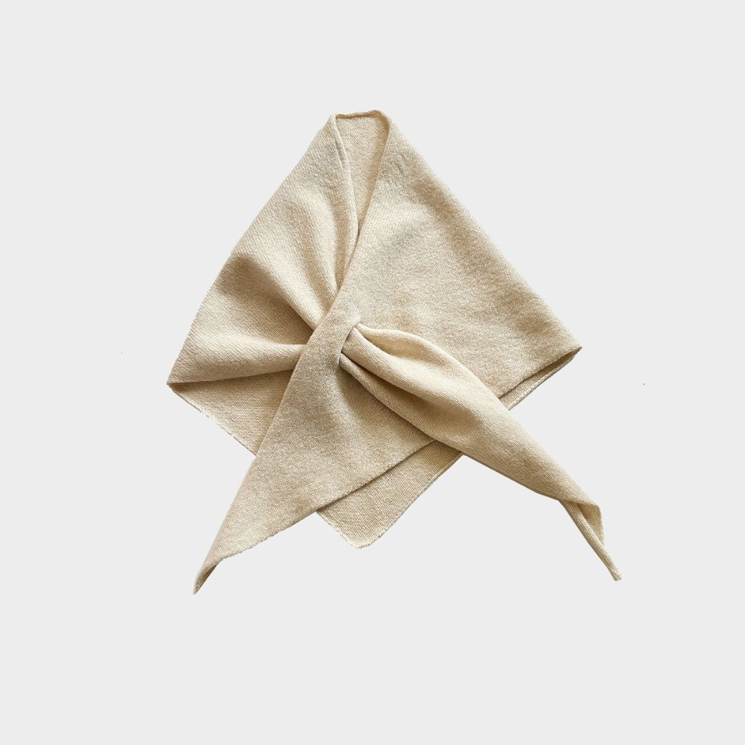 Cream knitted neckerchief on a white background.