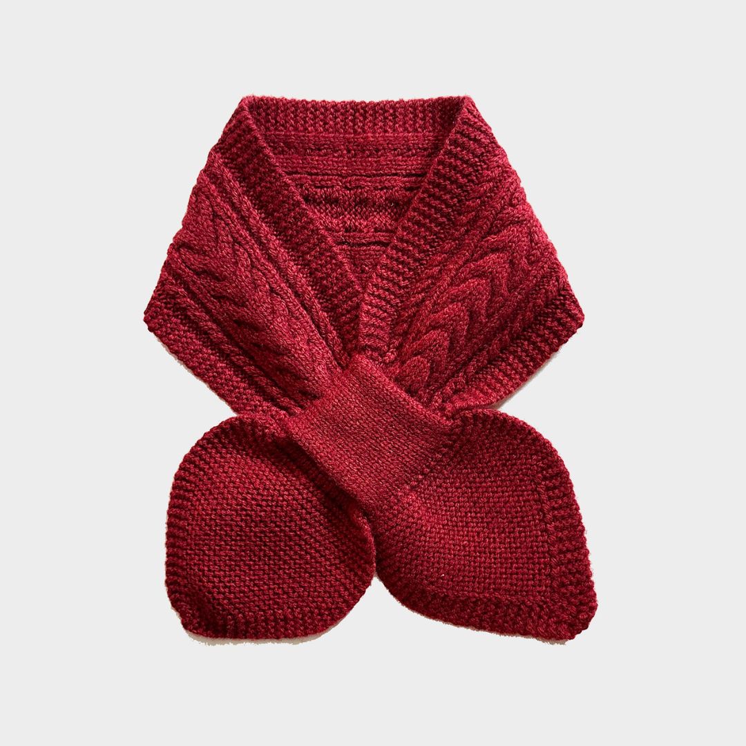 A dark red cable-knit scarf with matching knit mittens, displayed flat against a light gray background.