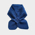 A royal blue cable-knit scarf folded and tied in a bow shape, displayed against a light gray background.
