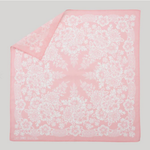 Pink bandana with white floral pattern on a gray background