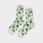 A pair of cream-colored crew socks with a green and dark blue paisley pattern, displayed against a light gray background.