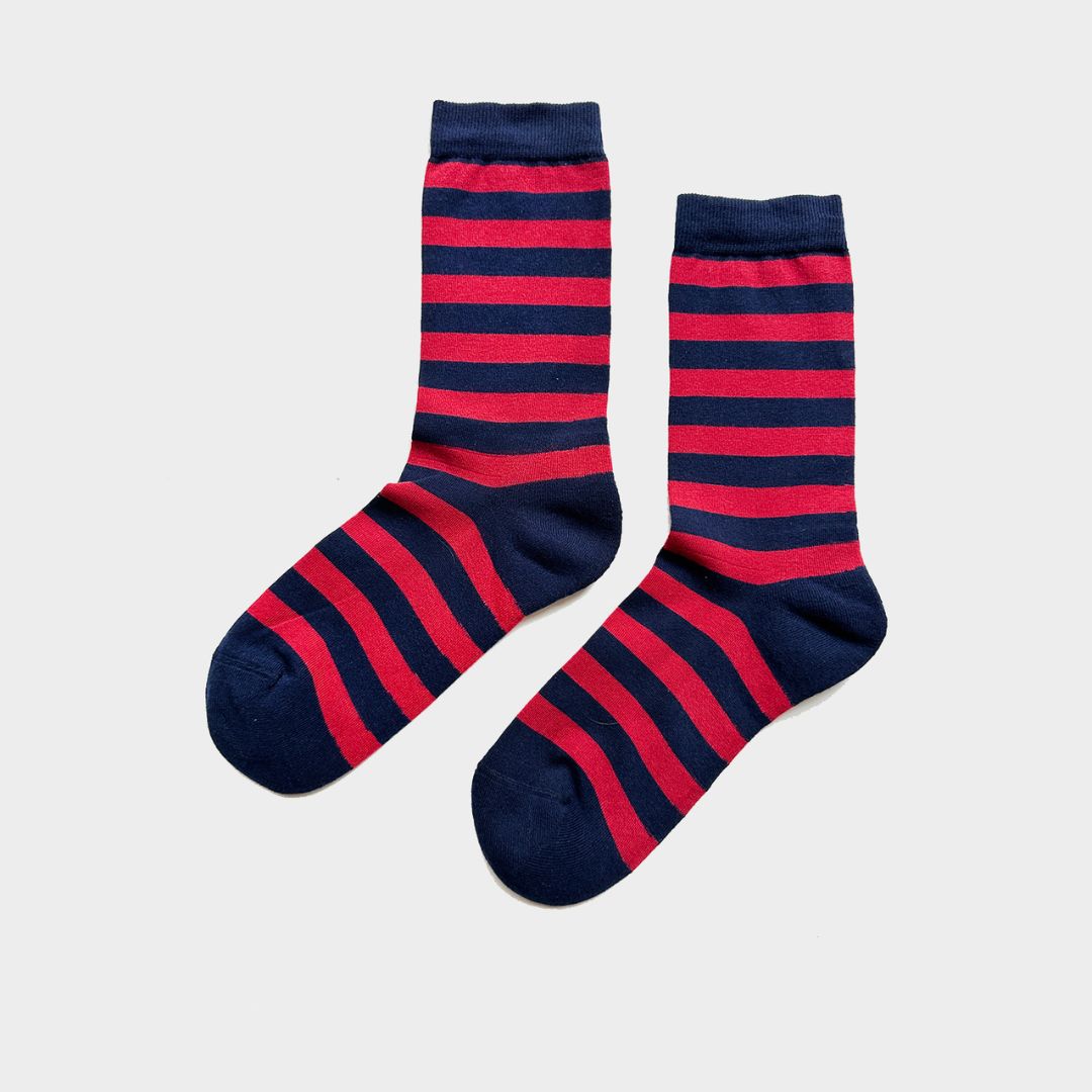 A pair of crew socks with horizontal navy blue and red stripes, displayed on a light gray background.