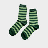 A pair of crew socks with horizontal stripes in dark forest green and light sage green, displayed against a light gray background.