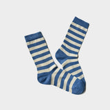 A pair of crew socks with horizontal blue and off-white stripes, displayed against a light gray background.