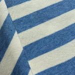 A close-up of a striped socks with alternating medium blue and off-white horizontal stripes.