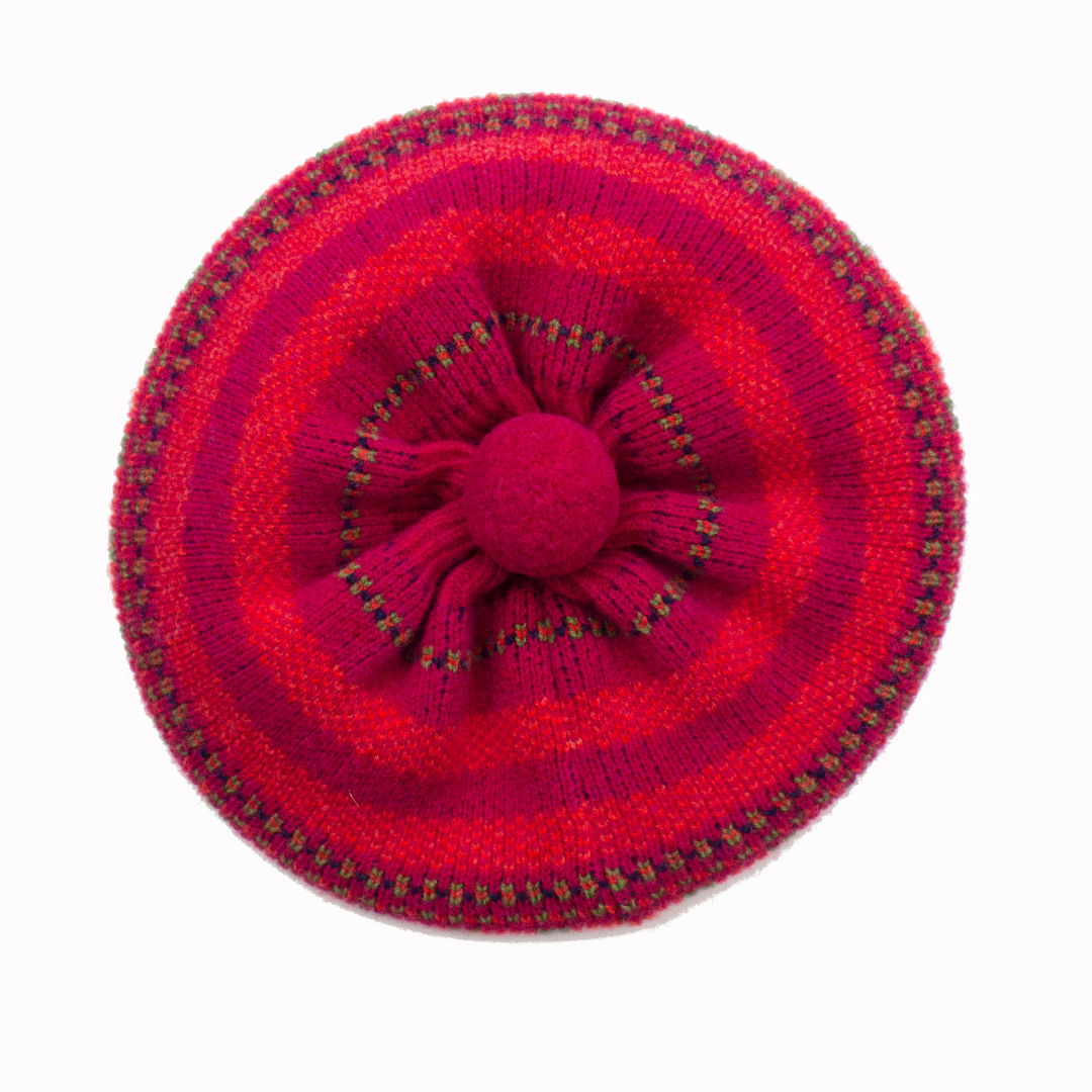 Red knitted beret with a flower design on a white background