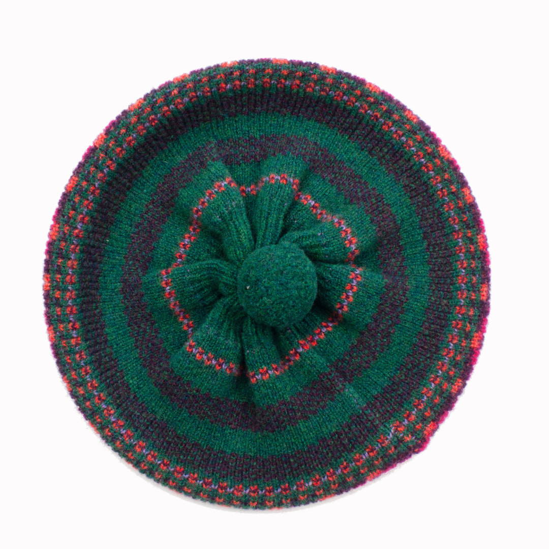 Knitted beret with a flower design on a white background