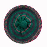 Knitted beret with a flower design on a white background