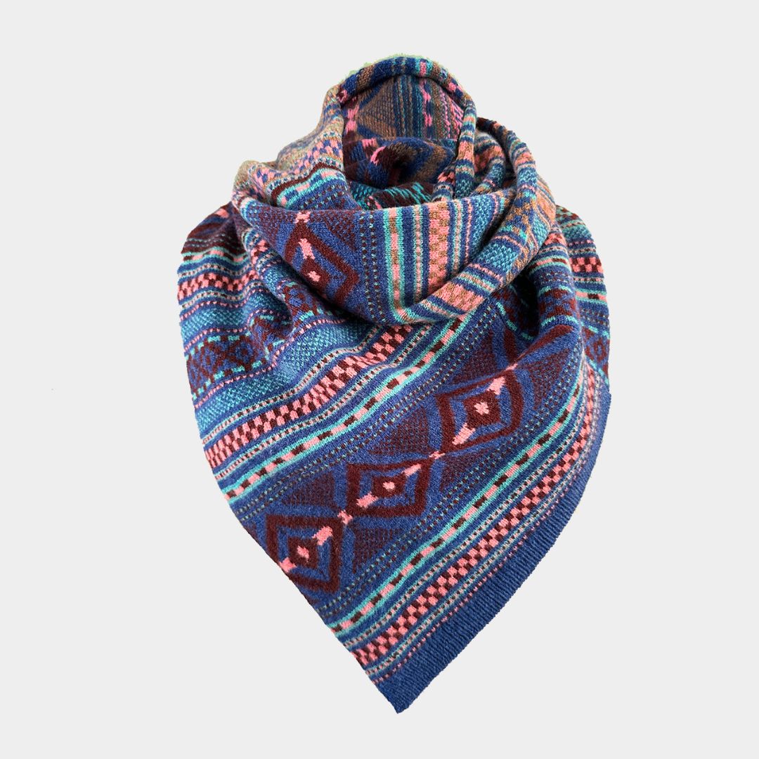 A folded knit scarf with a colorful geometric pattern in shades of blue, purple, pink, and beige, displayed against a light gray background.