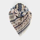 A knit triangular scarf with a geometric pattern in beige, navy blue, and brown, displayed on a light gray background.