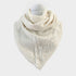 An off-white knit scarf with geometric patterns and pom-pom details, displayed on a mannequin neck against a light gray background.