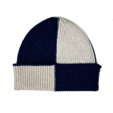 Two-tone navy and beige beanie hat on a white background