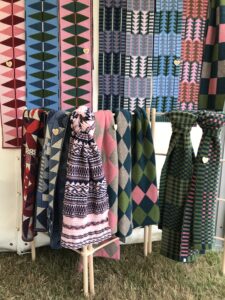 Various colourful scarves displayed on Cotswold Knit stand